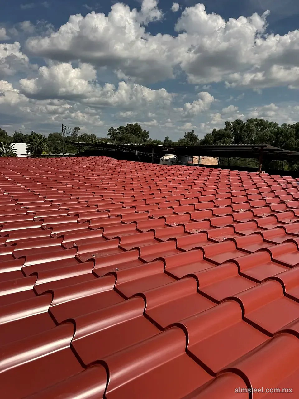 Techo de teja española roja bajo cielo con nubes